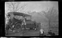 Elmer Cole and Al Schmitz stand by H. H. West's Cadillac in their camp near Taboose Creek, Big Pine vicinity, about 1920