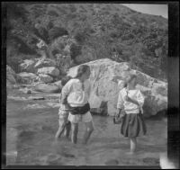 Elizabeth West, Frances West and Frances Cline wade in Big Tujunga Creek, Sunland-Tujunga vicinity, 1912