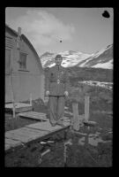 Fellow serviceman of H. H. West, Jr. poses in front of the barracks, Dutch Harbor, 1943