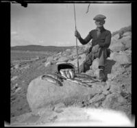 Abraham Whitaker poses with trout caught in Grant Lake, Mono County vicinity, 1929