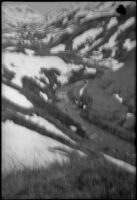 Creek winding between snow-covered mountains, Dutch Harbor, 1942