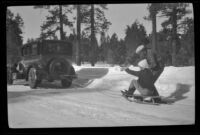 Mertie West and Neil Wells prepare for a sled ride behind H. H. West's Buick, Big Bear, 1932