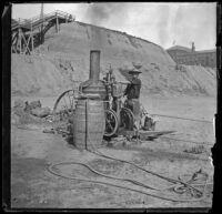 Man operates a steam engine on the beach, Santa Monica, about 1895