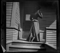 Daisy Kellum stands on the front porch of her family's home, Los Angeles, about 1899