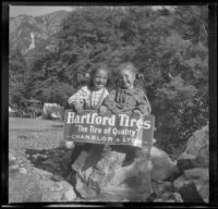 Elizabeth and Frances West hold a sign for Hartford Tires, Mount Baldy, 1914