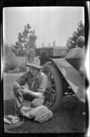 Harry Schmitz doing some mending, Burney Falls vicinity, 1917