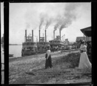 Wilhelmina West looks at steamboats on the Mississippi River, Burlington, 1900