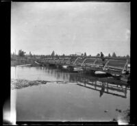 Harry Schmitz and Wilfrid Cline, Jr. stand on a bridge that spans the Rising River, Shasta County, 1917