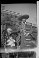 Dr. Bim Smith in his backyard with his mother who holds a baby, Los Angeles, 1939