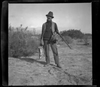 Webster Brain poses with rabbits and quails, Irwindale, about 1900