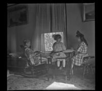 Minnie West, Frances West and Elizabeth West sit in the front room of the West home, Los Angeles, about 1910