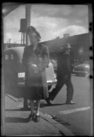 Mertie West stands on a corner, Seattle, 1947