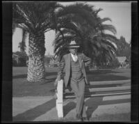 H. H. West leans on the back of a bench in Alhambra Park, Alhambra, 1933