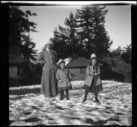 Frances and Elizabeth West playing in the snow while Mary West looks on, Mount Wilson, 1909