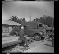 Mertie West sits on a wooden platform at the Southern Pacific Railroad depot, San Luis Obispo, 1942