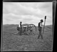 Two servicemen stand near a cannon in Los Angeles National Cemetery during Decoration Day, Los Angeles, about 1895