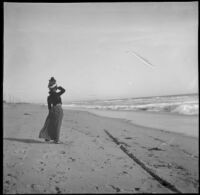 Pinkie (Ellen Lorene) Lemberger stands down on the sand and looks out at the ocean, Santa Monica, about 1900 or 1901