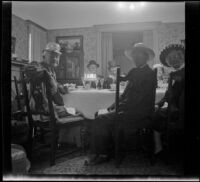 Forrest Whitaker, Dr. Bim Smith, Agnes Whitaker, Wayne West and Mrs. Brooks sit around the West's dining table during a birthday dinner, Los Angeles, 1944