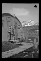 Four servicemen stand on the front step of their quarters, Dutch Harbor, 1943