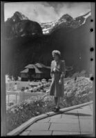 Mertie West stands on a terrace near the swimming pool at Chateau Lake Louise, Lake Louise, 1947