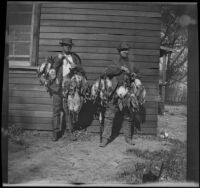 Mark Bailey and Billy MacNider pose with ducks outside the clubhouse, Gorman vicinity, circa 1910s