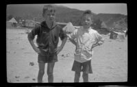 Ambrose Line and H. H. West, Jr. pose at the beach, Topanga, about 1922