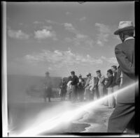 Mertie West and her tour group stand alongside a spring in Upper Geyser Basin, Yellowstone National Park, 1942