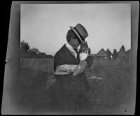 Earl Kellum cradles a rag doll, Los Angeles, about 1899