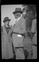 Ralph Hiatt speaks to a woman at the Iowa Picnic in Lincoln Park, Los Angeles, 1939