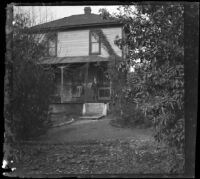 Ed Smith stands on the porch of the ranch house, Pomona, about 1895