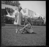 Frances and Elizabeth West in the backyard of the West's house at 165 South Harvard Boulevard, Los Angeles, about 1914