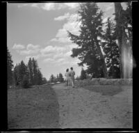 A couple strolls the path along the rim of Crater Lake, Crater Lake National Park, 1942