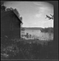 Crane Lake's high waters reach the Alamos Gun Club clubhouse, Gorman vicinity, circa 1910s