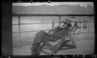 H. H. West dozing on the ship's deck in the sun, Cordova, 1946