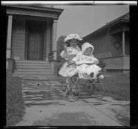 Elizabeth and Frances West pose on a front walk wearing white outfits, Los Angeles, about 1907