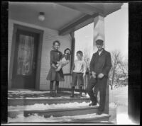 Henry Lemberger stands on a porch with his children, Burlington, 1917