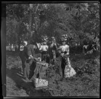 H. H. West serves drinks to his cousins and mother on an island in the Mississippi River, Burlington, 1900