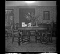 Vase of flowers, cards, and a mug that reads "Mother" on the West's dining room table, Los Angeles, 1943