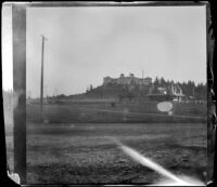 Raymond Hotel and railroad station standing in the distance, Pasadena, about 1898