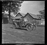 Wilfrid Cline, Jr. and Harry Schmitz sit in H. H. West's Buick while visiting Cassel, Burney Falls vicinity, 1917