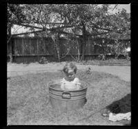 Ambrose Cline sits in a tub in the West's backyard, Los Angeles, about 1916