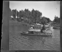 Man steers a bicycle boat with passengers on the lake at Hollenbeck Park, Los Angeles, about 1898