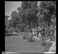 Mertie West walks with a tour group through the Temple Square grounds, Salt Lake City, 1942