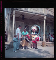 Man and woman dressed as American Indians greet a father and son ad Knott's Berry Farm, Buena Park, 1957