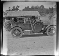 Wilfrid Cline, Jr. and Harry Schmitz sit in H. H. West's Buick in front of the McArthur general store, Shasta County, 1917