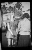 Robot advertising for Alpha the Robot while walking through the California Pacific International Exposition near the Cafe of the World, San Diego, [about 1935]