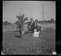 John Teel, Mary A. West, Hattie Cline and baby Ambrose Cline sit in a field at John Teel's ranch, Los Angeles, [about 1915]