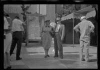 Myrtle and Evert West stand in front of Grauman's Chinese Theatre, Los Angeles, 1941