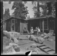 Neil Wells, Mertie West, Frances West Wells and H. H. West, Jr. sit on the back porch of the cabin, Big Bear Lake, 1932