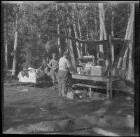 Mertie West, Edith Shaw, and Agnes Whitaker next to a temporary camping kitchen at Convict Lake, Mammoth Lakes vicinity, 1929